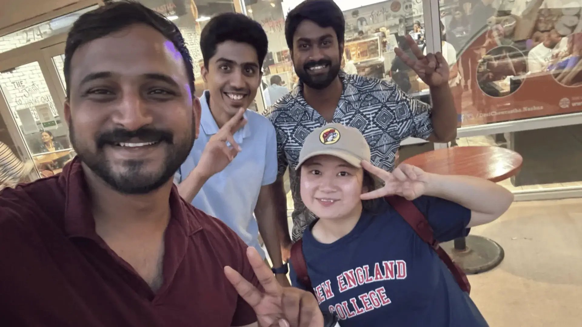 GoElite representative and international students from New England College connecting and building community during a student gathering.