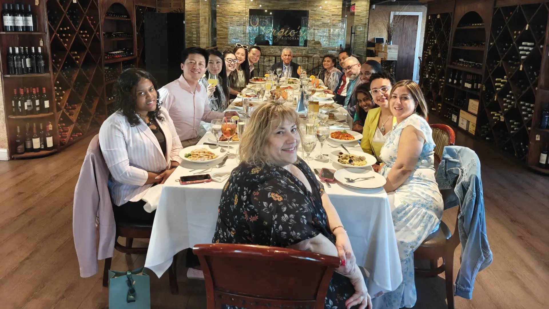 GoElite team and Monroe partners gathered for a business dinner at a restaurant.
