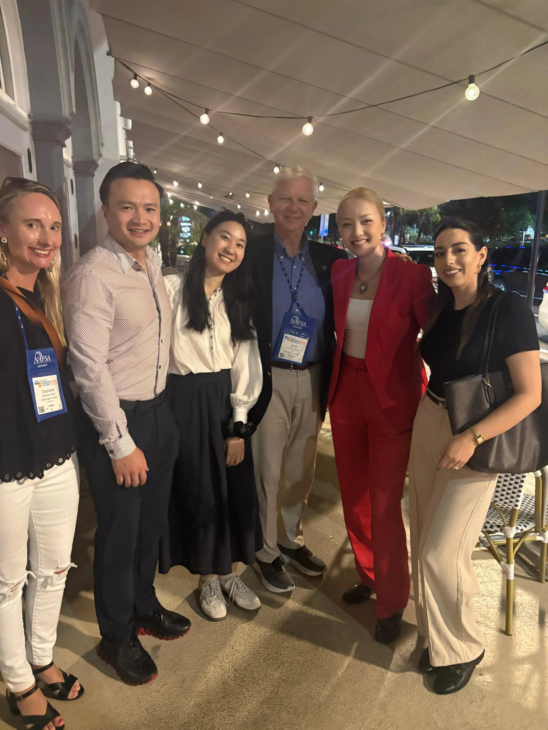 GoElite team members networking with education and immigration professionals at a NAFSA conference event.
