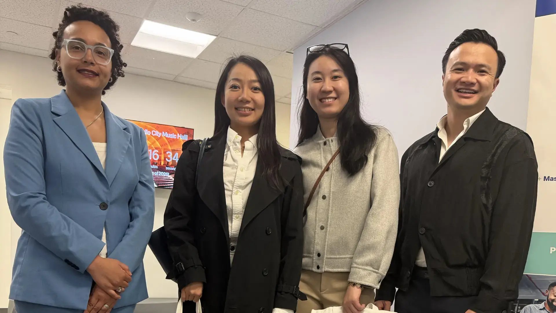 GoElite team members posing together at a professional networking event.