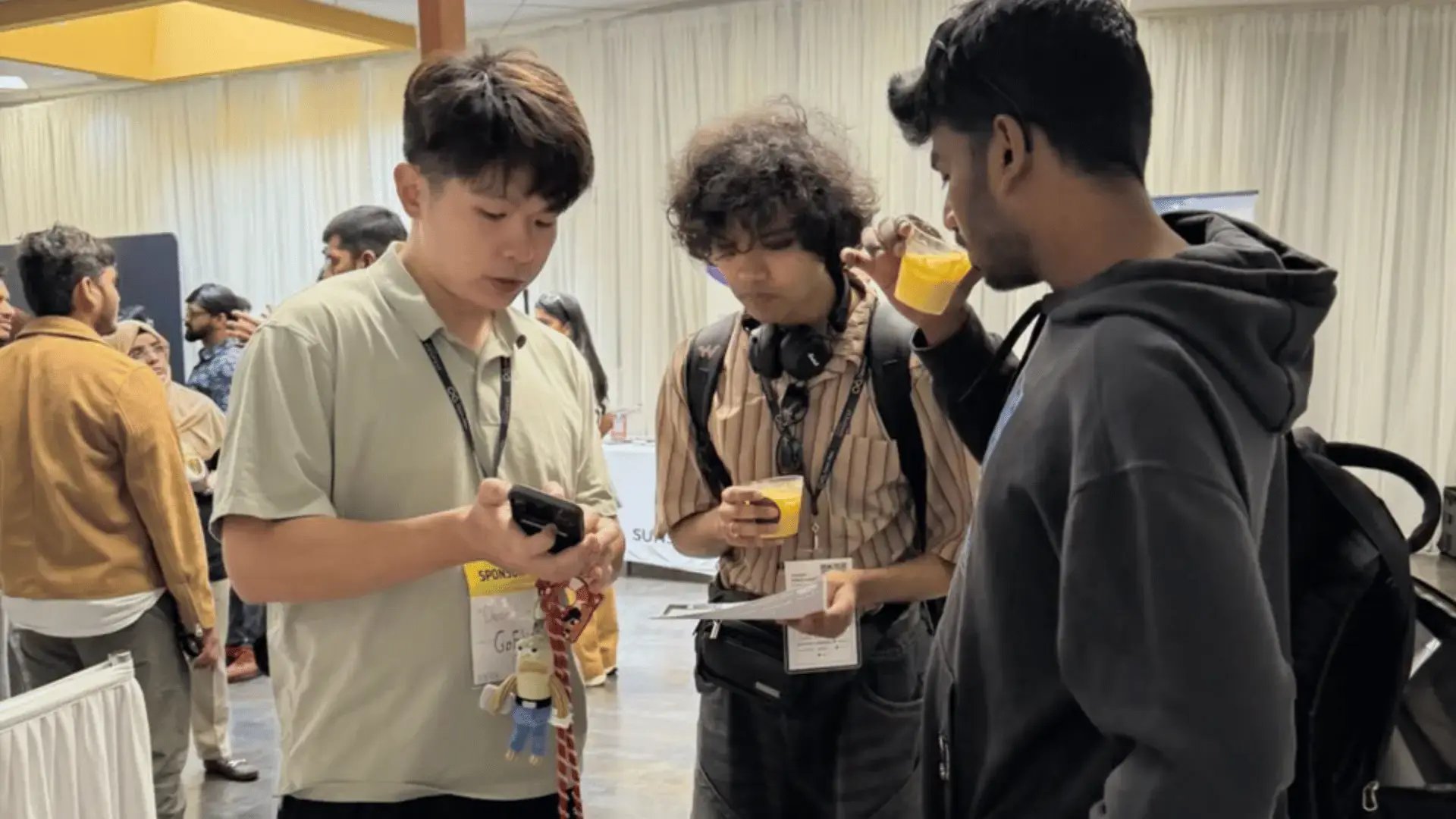 GoElite team member, Dean Liu, speaks with international students during the Open Atlas Summit in Milpitas, California.